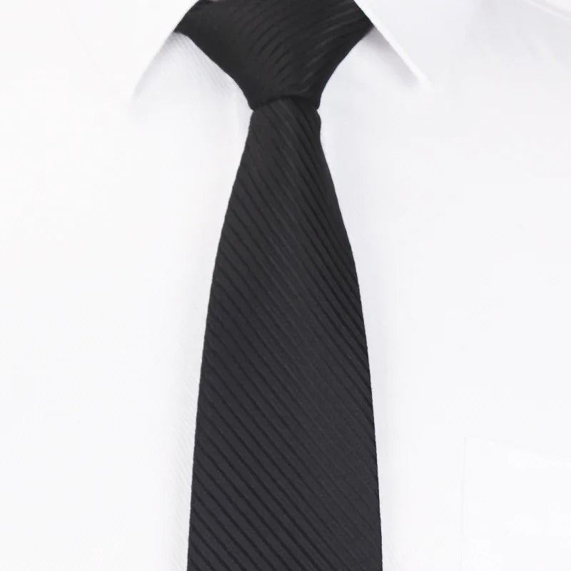 Black textured slim necktie on a white dress shirt with a pointed collar