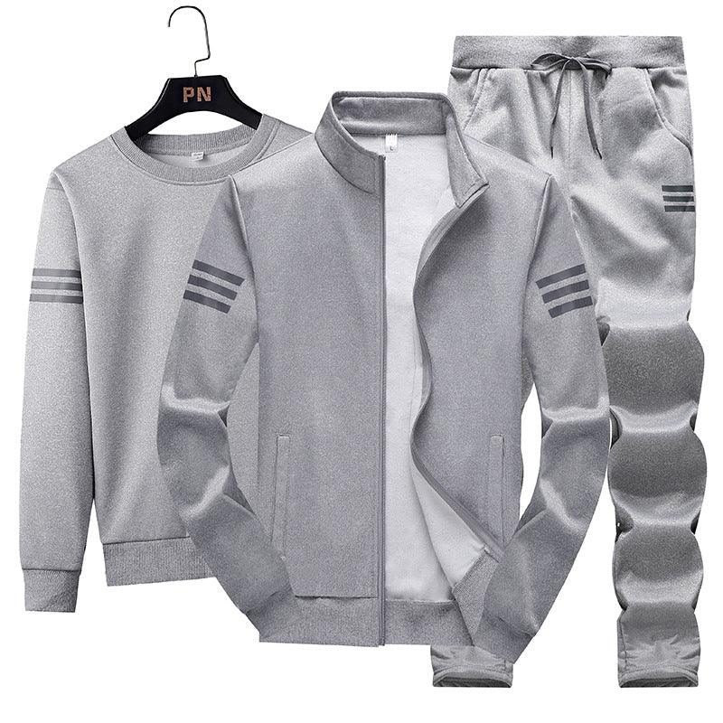 Gray three-piece men's tracksuit set with zip jacket, sweatshirt, and drawstring pants featuring triple stripe accents