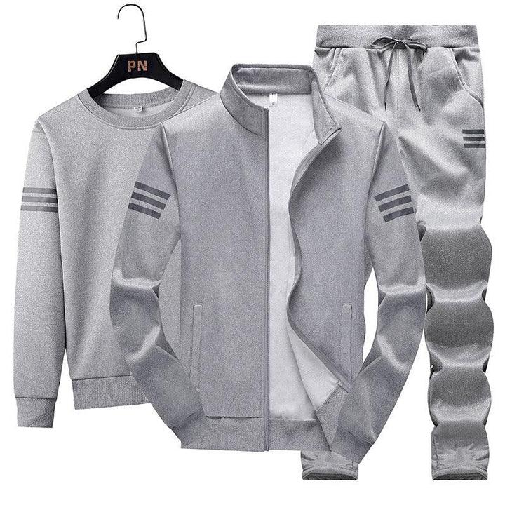 Gray three-piece men's tracksuit set with zip jacket, sweatshirt, and drawstring pants featuring triple stripe accents