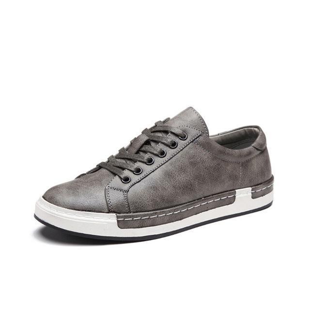 gray casual men's sneaker with white sole and lace-up design on white background