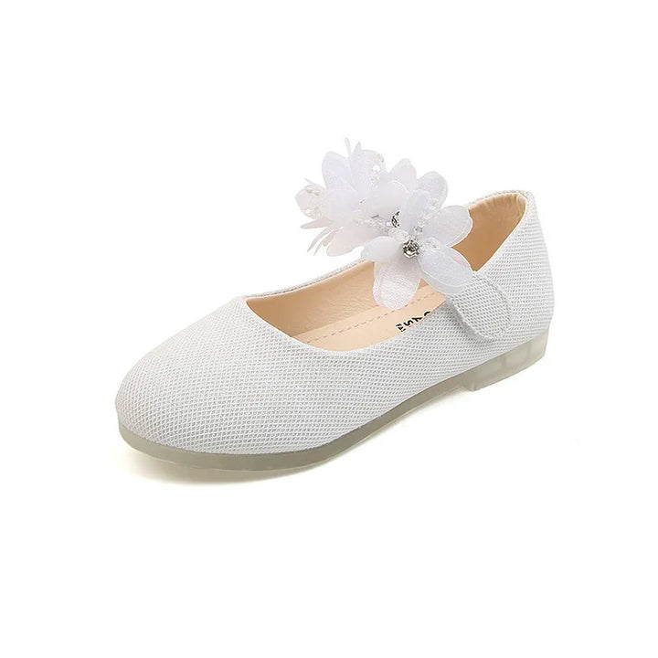 White textured girls' Mary Jane shoe with decorative fabric flowers and rhinestones on strap