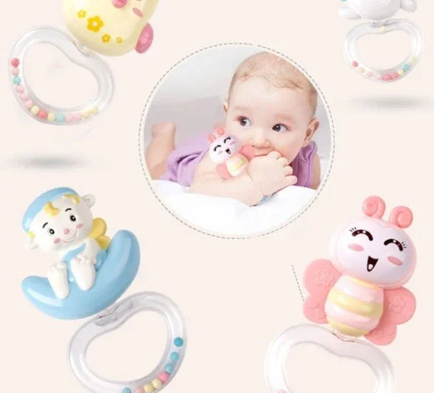 Baby lying down chewing on colorful animal-themed teething toy with clear handle beads