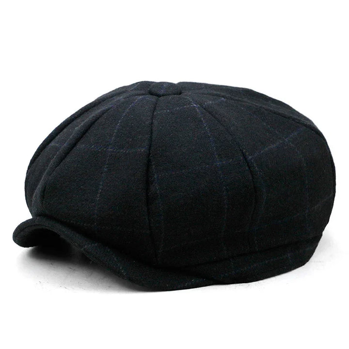 Black newsboy cap with subtle plaid pattern and short curved brim on white background