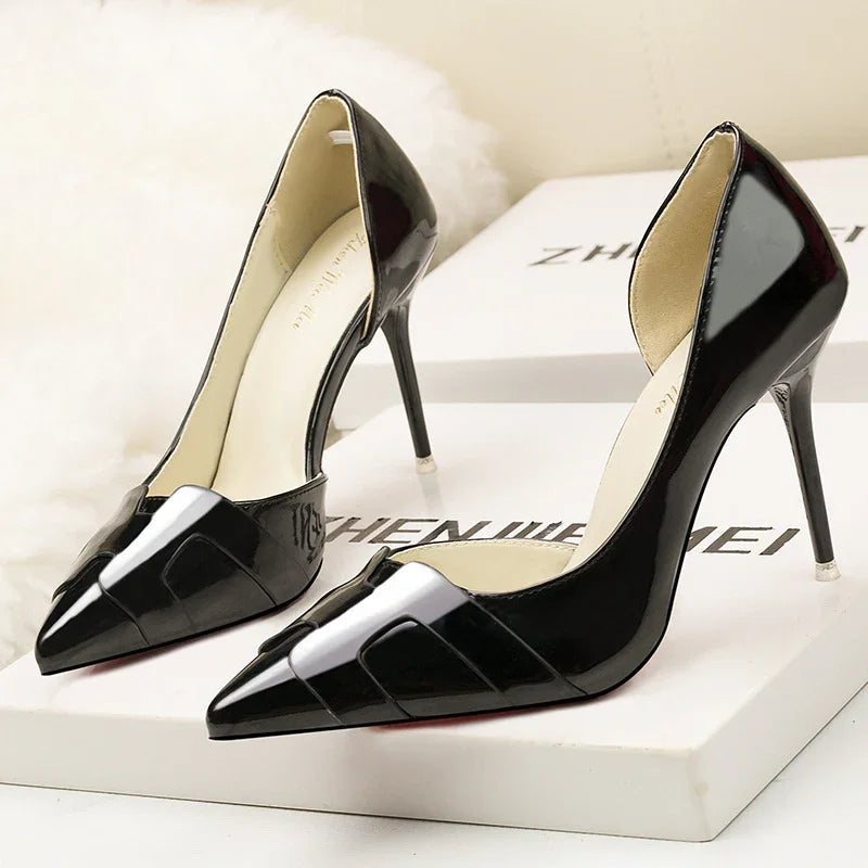 Stylish black patent leather pointed-toe stiletto heels on white branded box