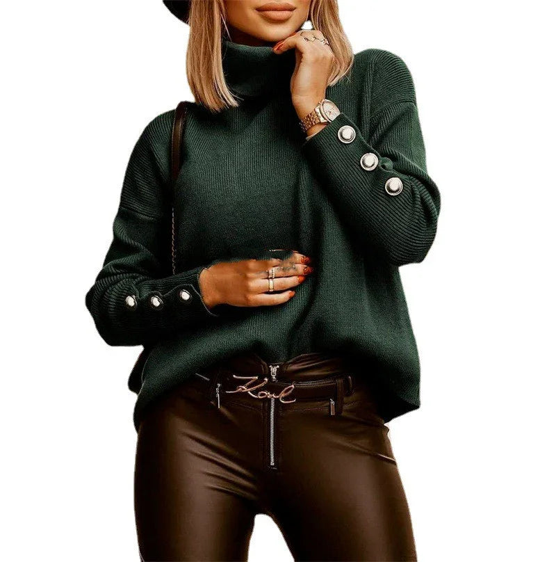 Woman wearing dark green turtleneck sweater with decorative buttons on sleeves and black leather pants
