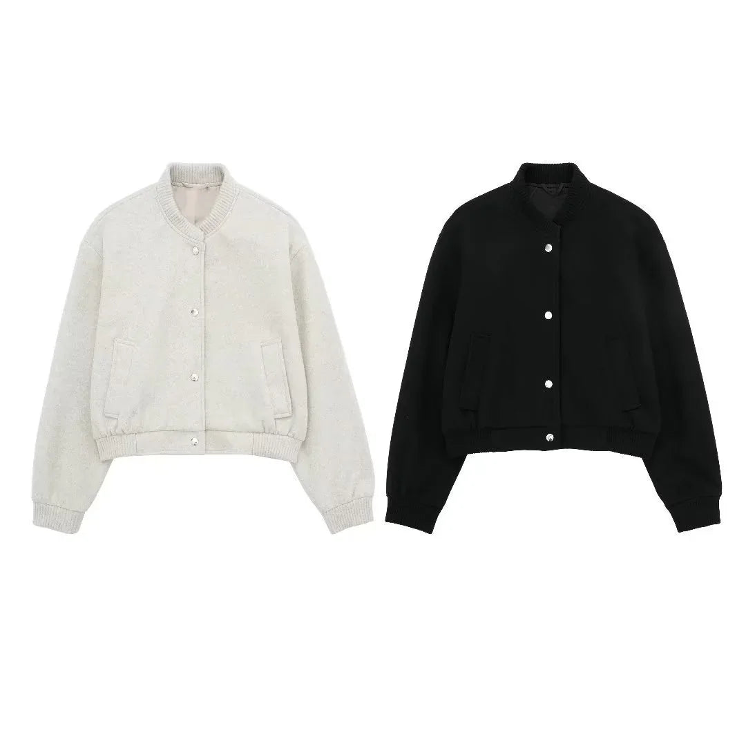 Pair of cropped bomber jackets in off-white and black with snap buttons and side pockets