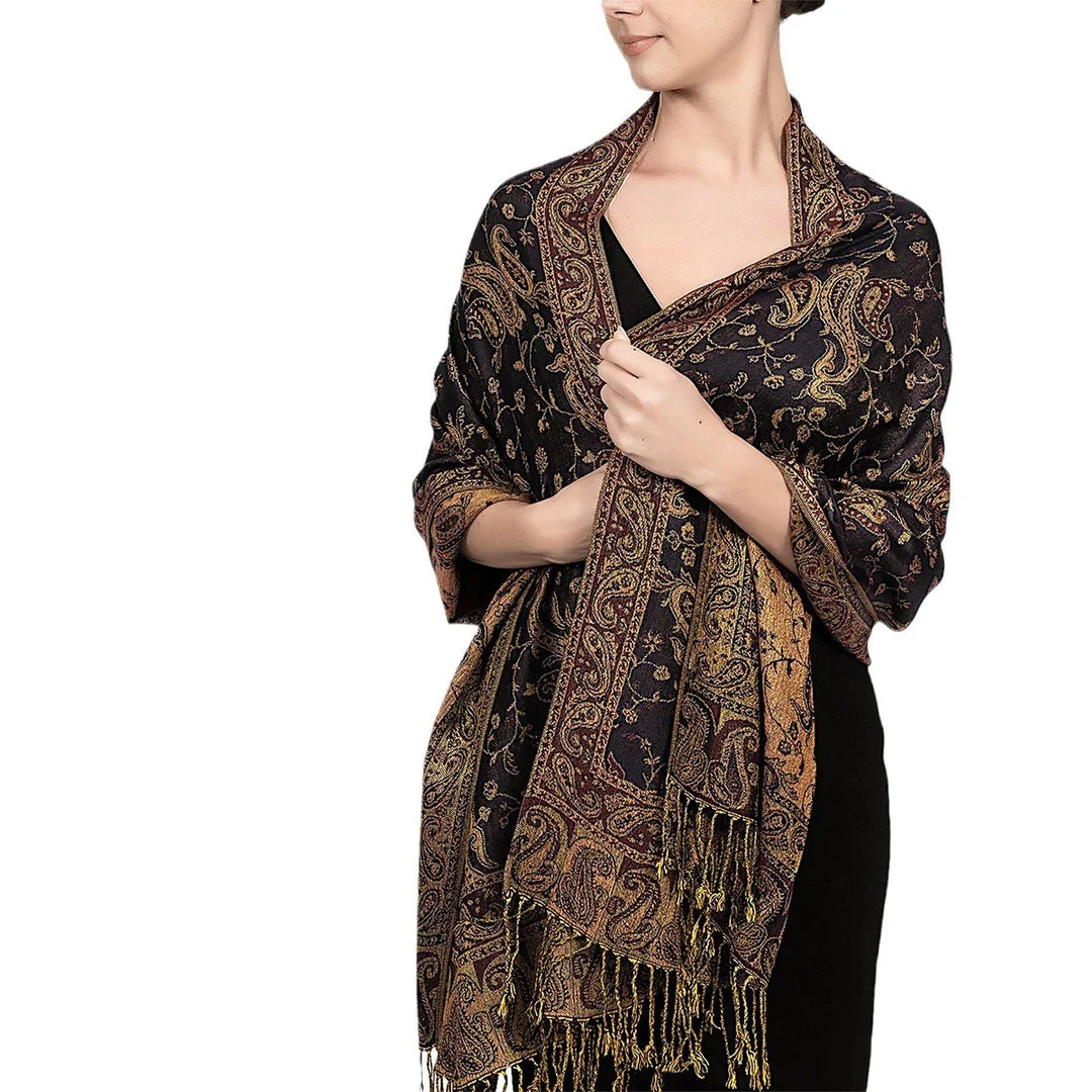 Woman wearing black dress and elegant black and gold paisley patterned shawl with fringes