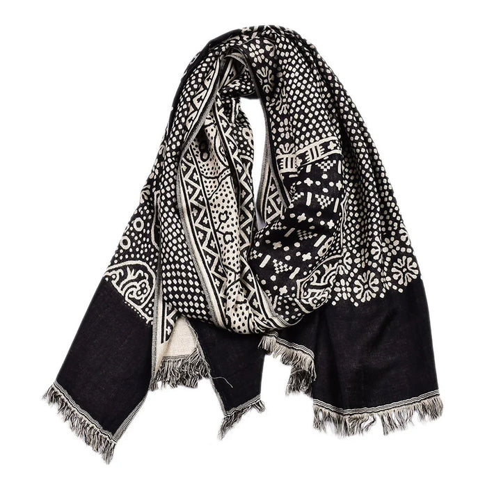 Black and white patterned scarf with geometric and floral designs and fringed edges