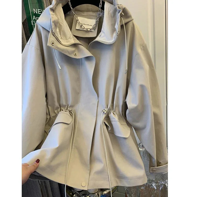 Beige hooded jacket with adjustable drawstrings and large front pockets on hanger