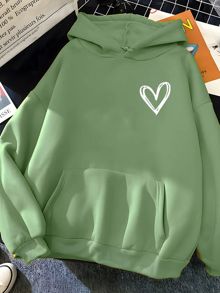 Light green hoodie with white heart graphic on chest and front kangaroo pocket displayed on flat surface