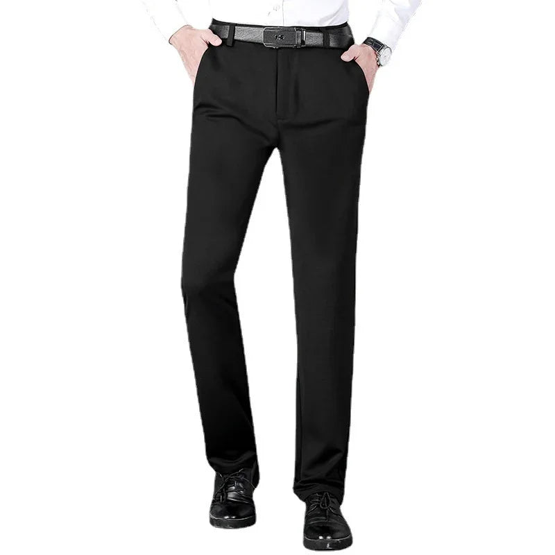 Man wearing black dress pants with a black belt, white shirt, and black leather shoes