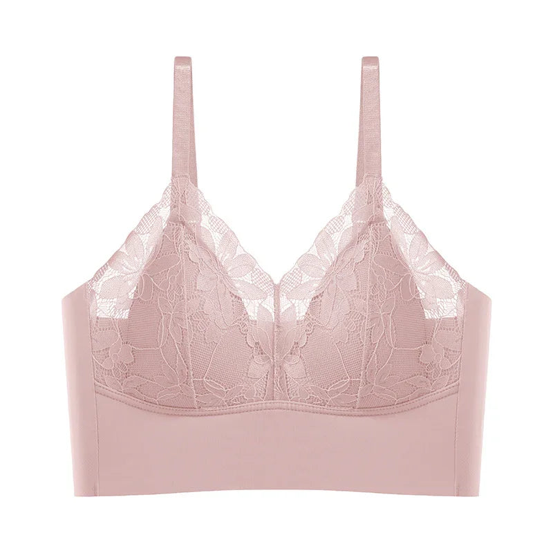 Light pink lace bralette with floral pattern and adjustable straps on white background
