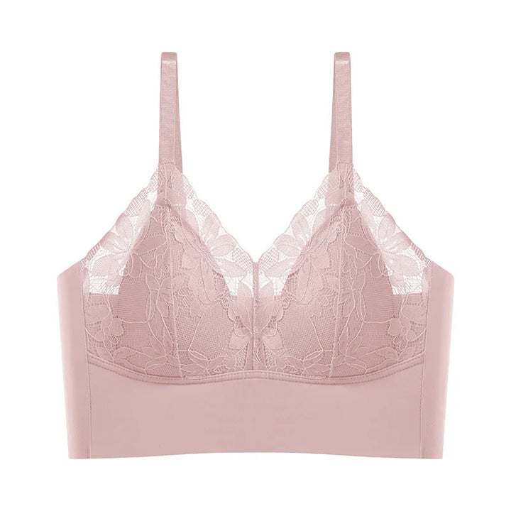 Light pink lace bralette with floral pattern and adjustable straps on white background