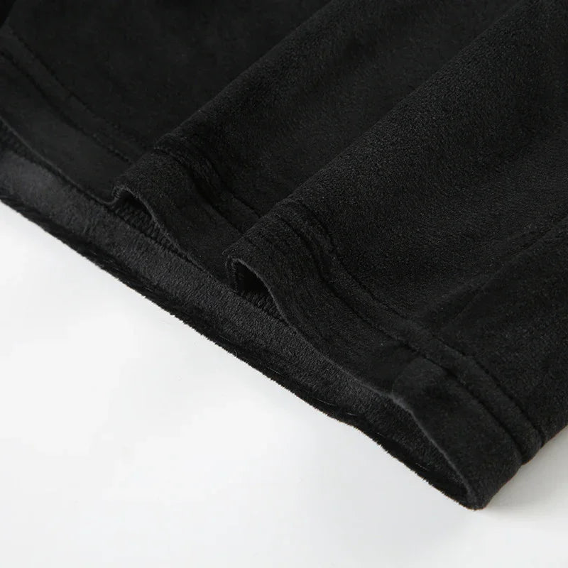 Close-up of black fleece fabric with detailed stitching on garment edge