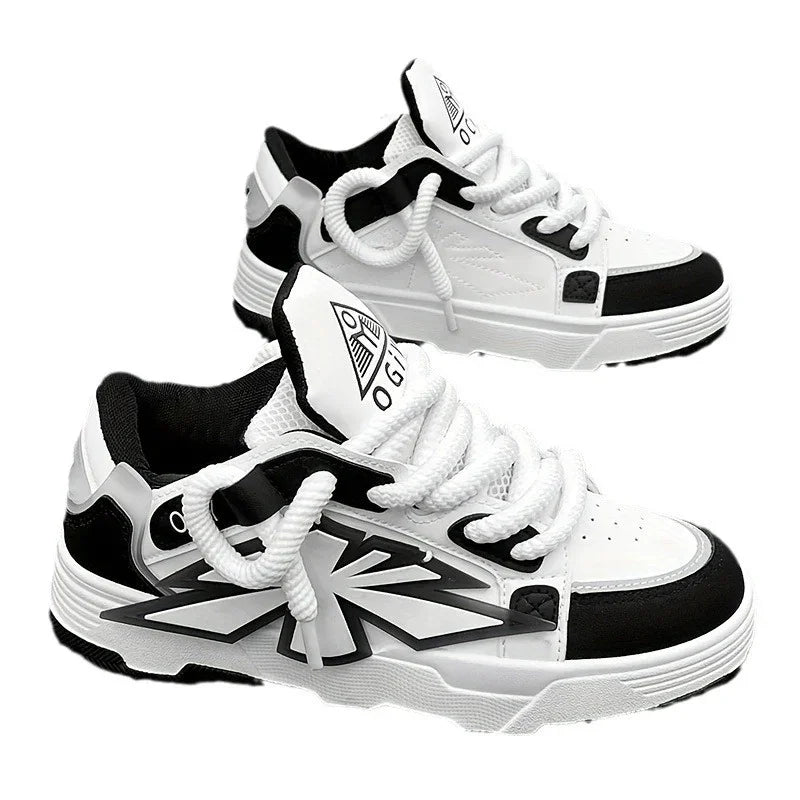 Pair of white and black OGIX sneakers with thick white laces and graphic design on sides