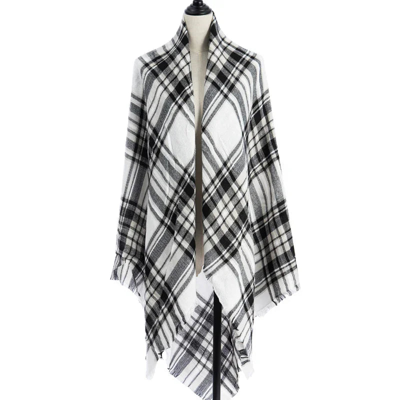 Black and white plaid shawl draped on a dress form mannequin against white background
