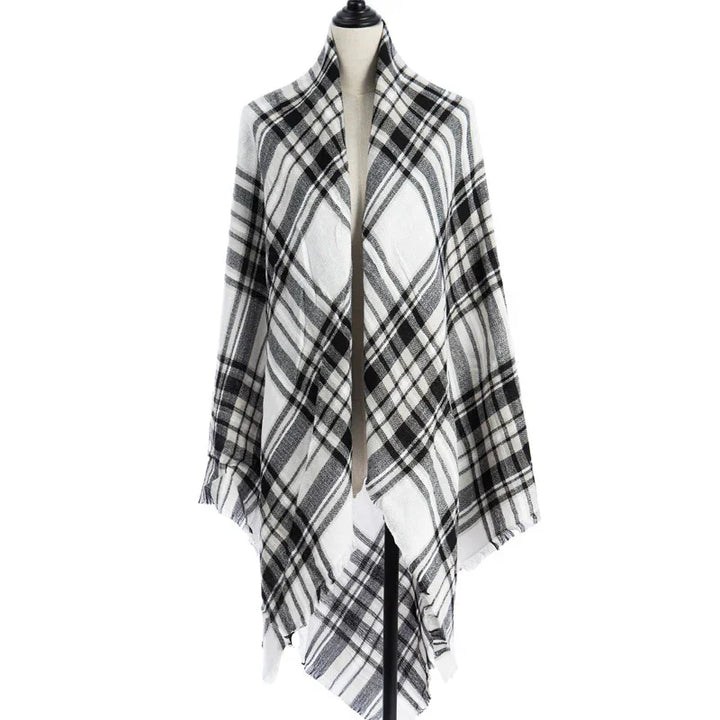 Black and white plaid shawl draped on a dress form mannequin against white background