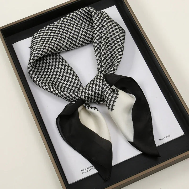 Black and white houndstooth silk scarf with black and white border, stylishly knotted in luxury box