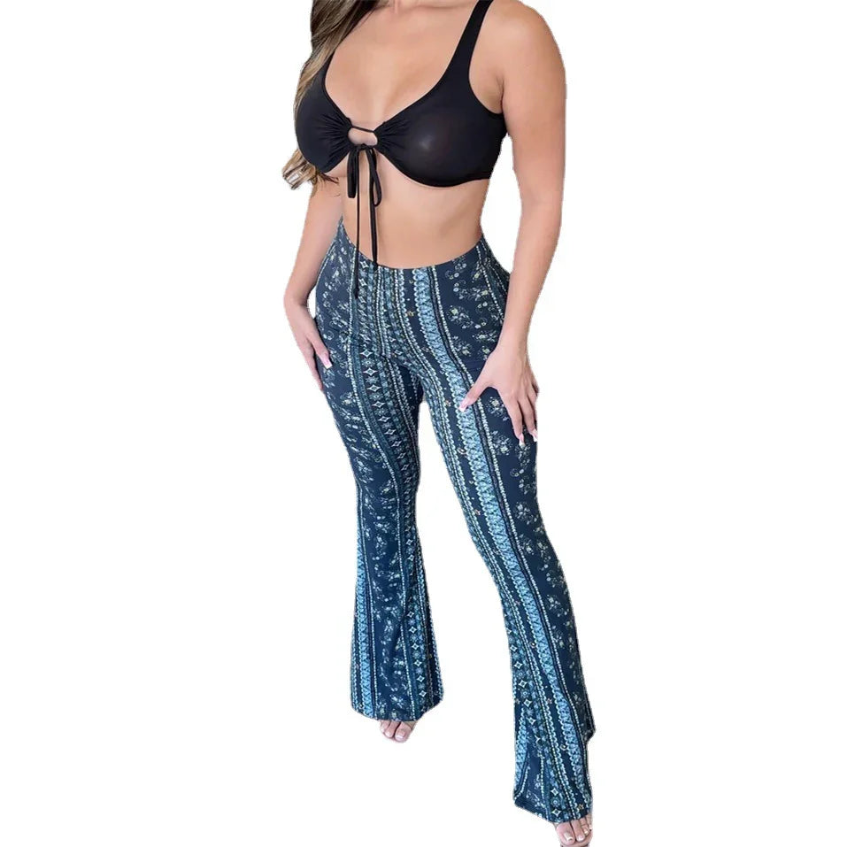 Woman wearing black tie-front crop top and patterned flared pants with vertical stripes