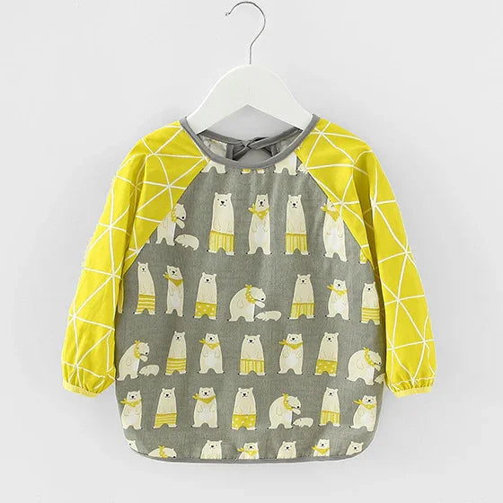 Toddler's long-sleeve bib with yellow geometric sleeves and gray body featuring cartoon polar bears in yellow shorts
