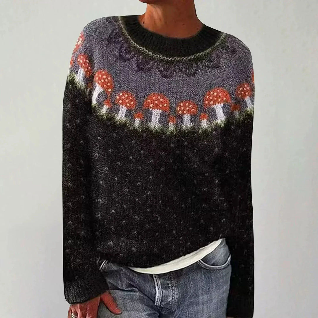 Cozy black sweater with red and white mushroom pattern around the yoke worn with blue jeans