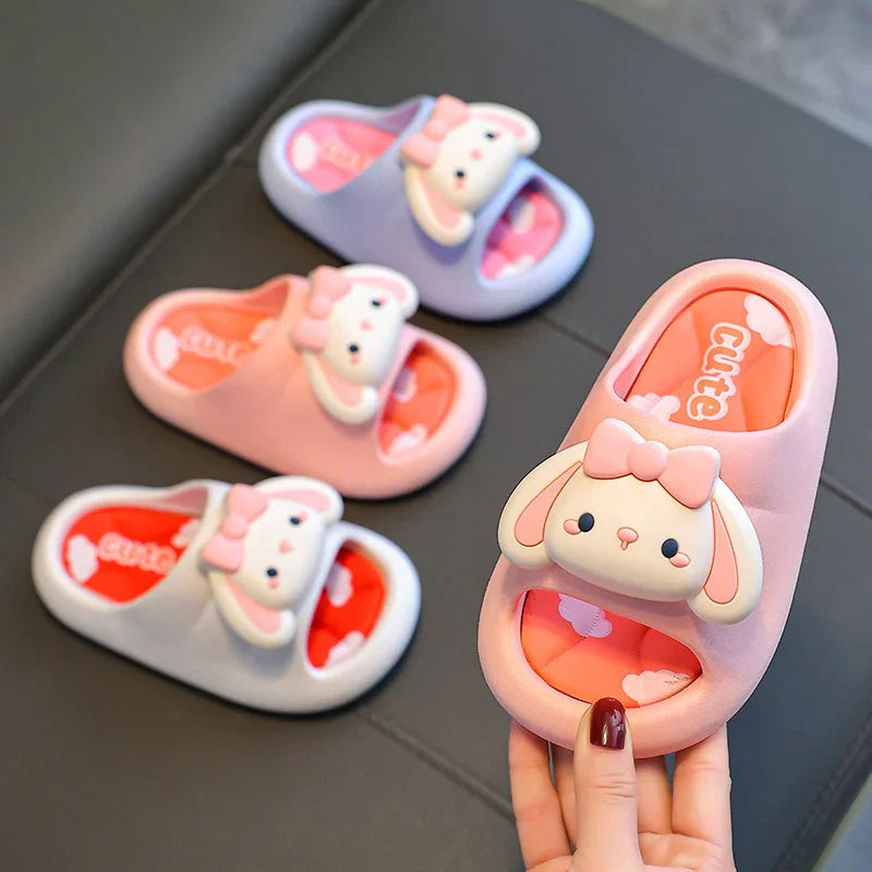 Colorful cute children's slippers with bunny face and bow design in pink, purple, and white colors