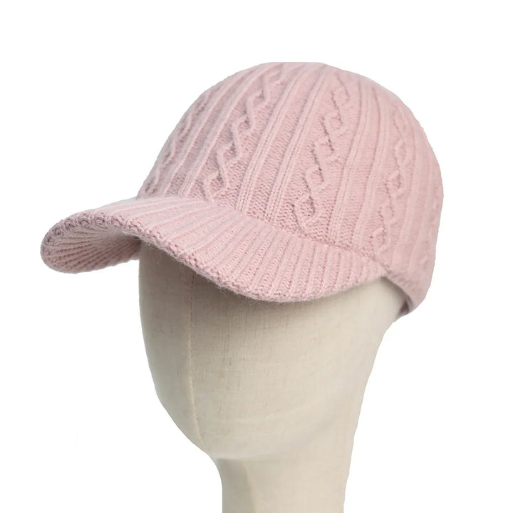 Pink knitted cable pattern cap with brim on mannequin head
