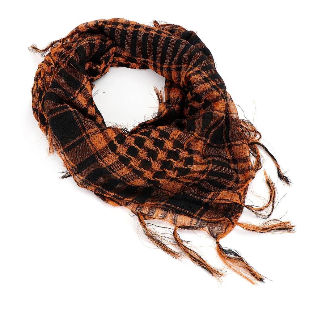 Black and orange checkered keffiyeh scarf with fringed edges on white background