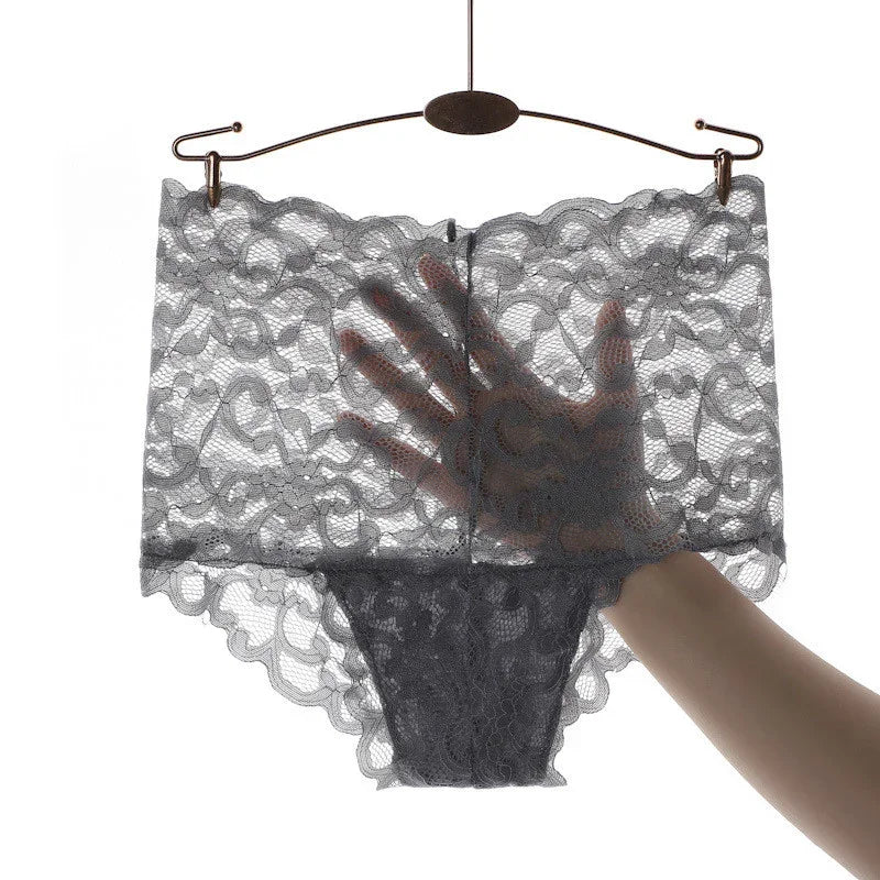 Black lace high-waisted women's underwear with floral pattern displayed on hanger with hand behind fabric