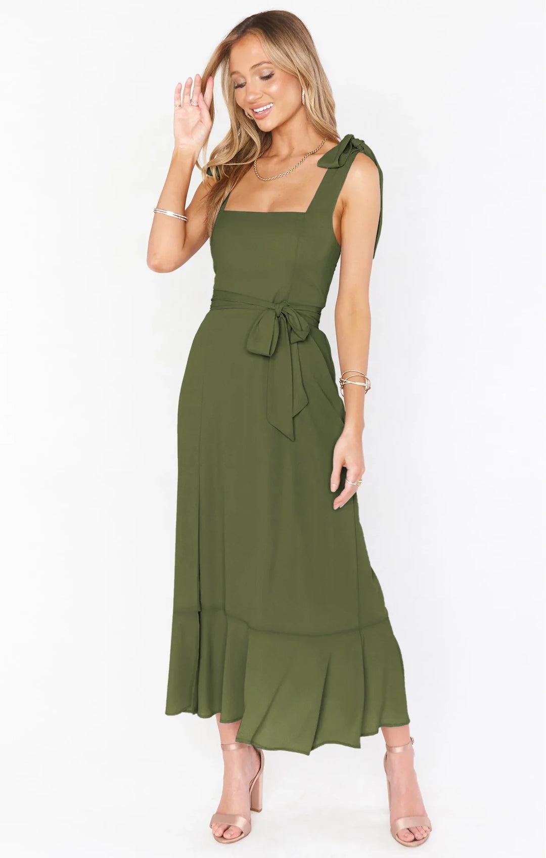 Smiling woman in olive green sleeveless midi dress with bow shoulder straps and tie waist