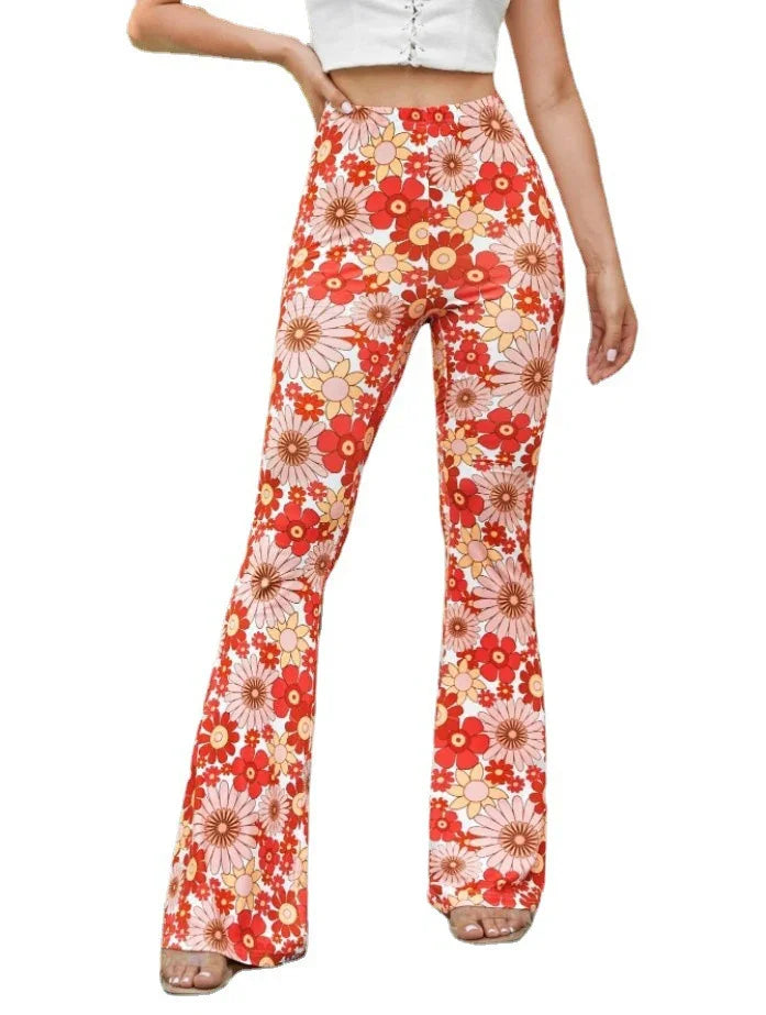 Woman wearing high-waisted, flared pants with red, orange, and pink floral print and beige sandals
