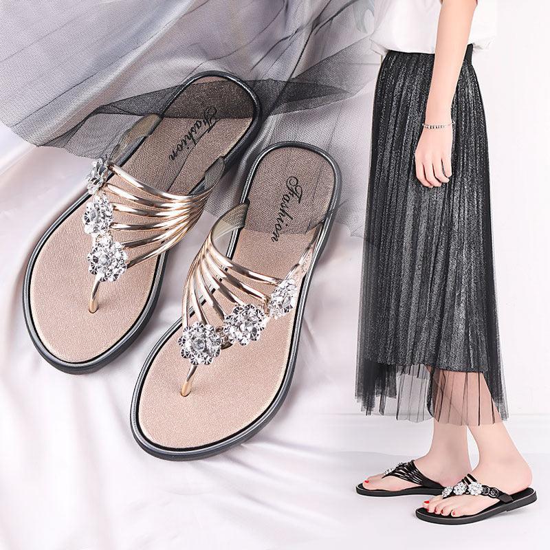 Elegant black women's sandals with crystal decorations, paired with a black pleated skirt and white top