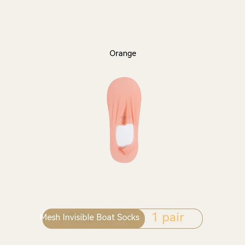 One pair of orange mesh invisible boat socks on beige background