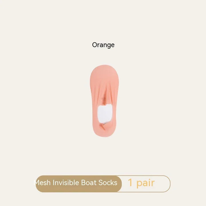 One pair of orange mesh invisible boat socks on beige background
