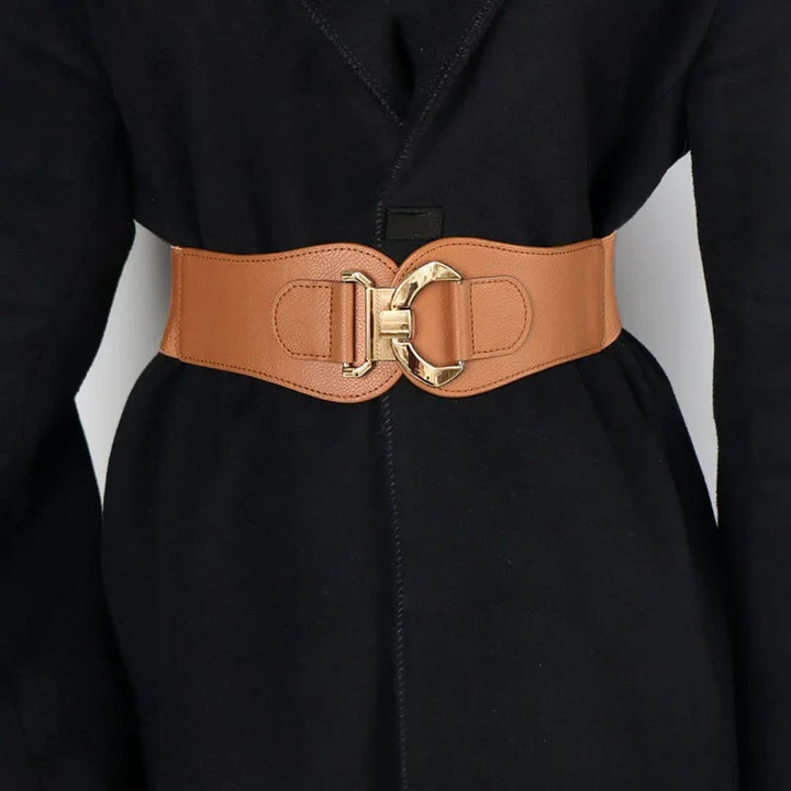 Wide tan leather waist belt with gold buckle on black coat outfit
