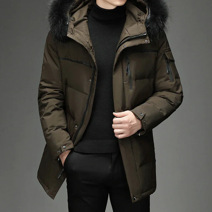 Man wearing dark green winter parka with black fur hood and black turtleneck sweater