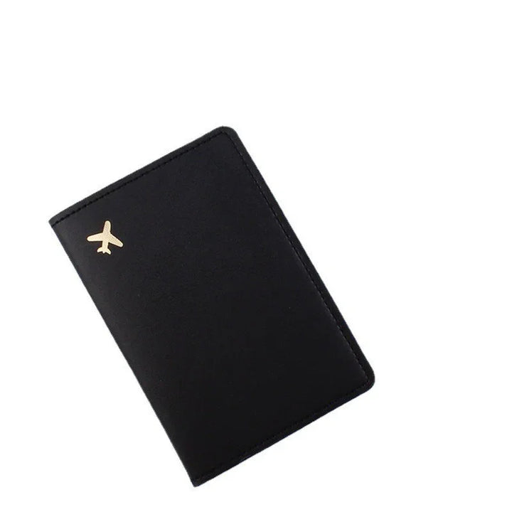 Black leather travel passport holder with small gold airplane icon on cover