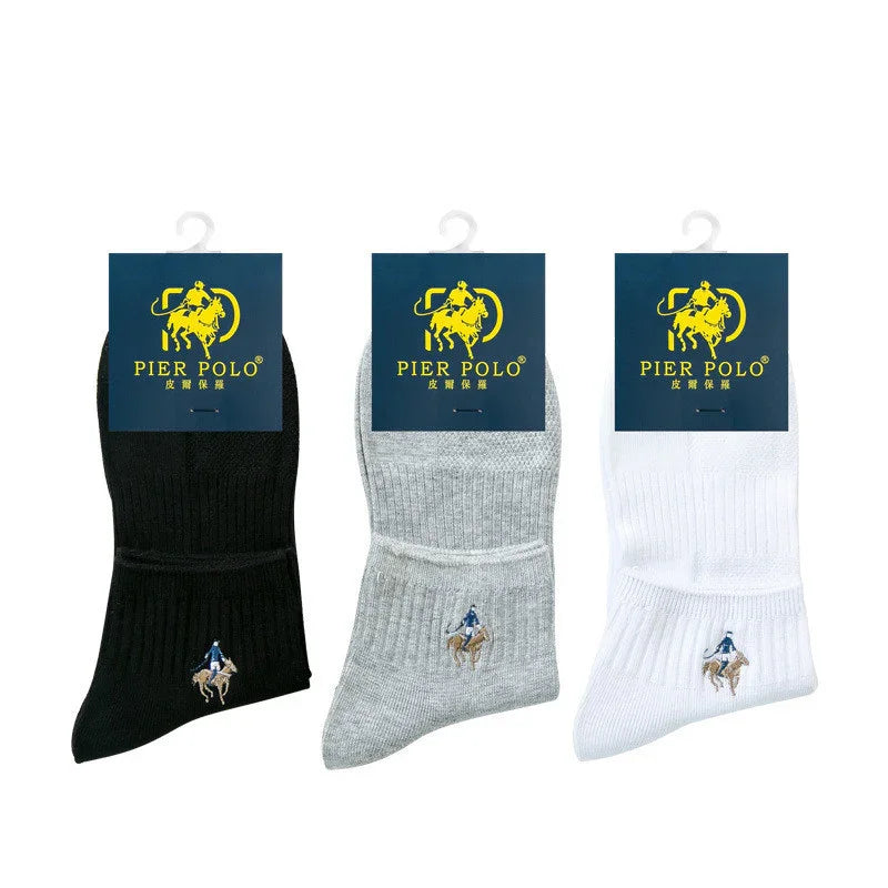 Three pairs of Pier Polo socks in black, gray, and white with polo player logo and blue packaging