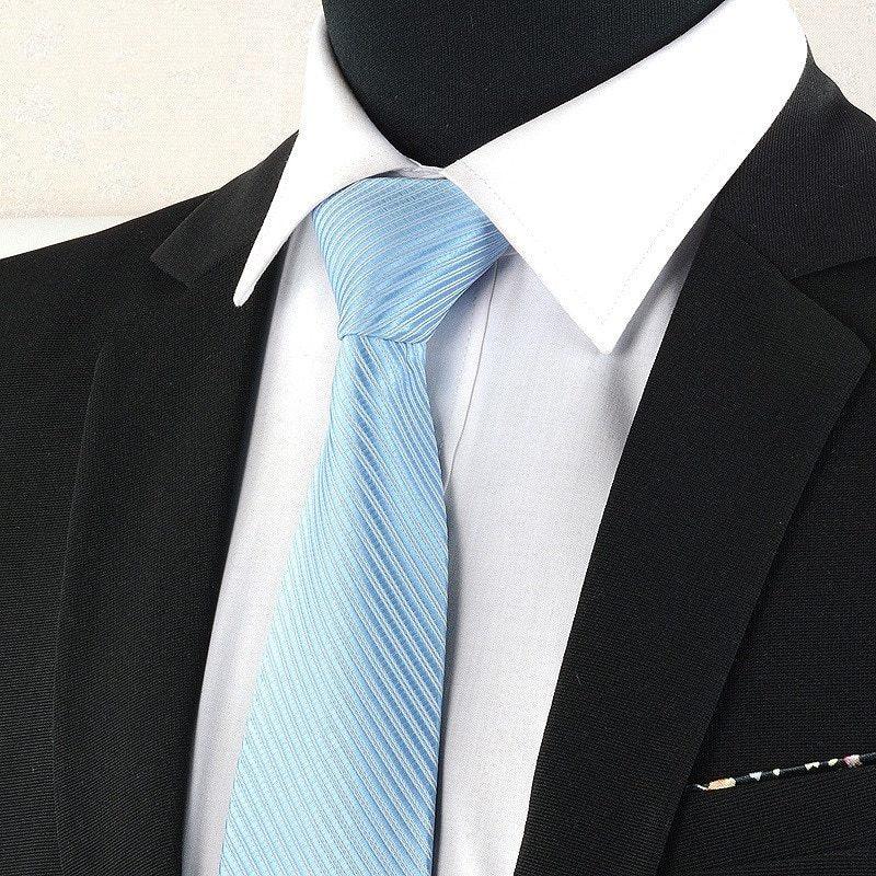 Black suit jacket with white dress shirt and light blue striped tie on mannequin