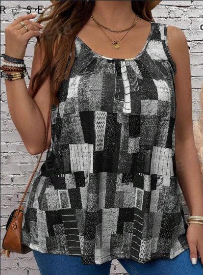Woman wearing black and white geometric sleeveless top with layered gold necklaces and bracelets against a white brick wall