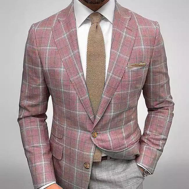 Man wearing stylish pink plaid blazer with white shirt, beige textured tie, and gray trousers