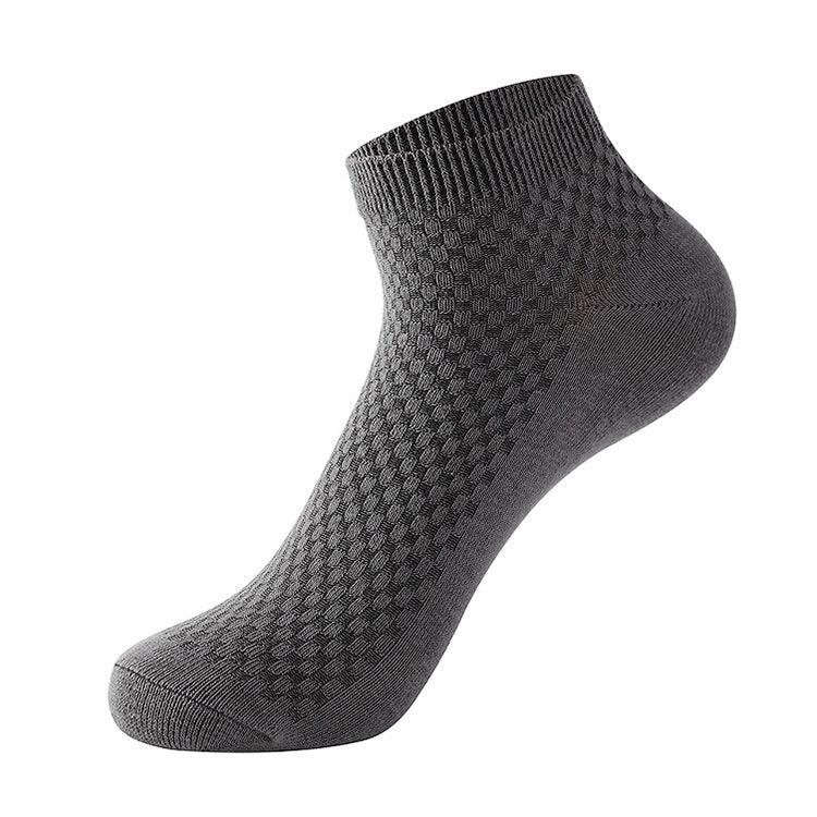 single gray ankle sock with textured geometric pattern on white background