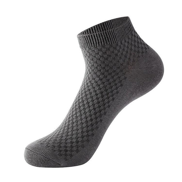 single gray ankle sock with textured geometric pattern on white background