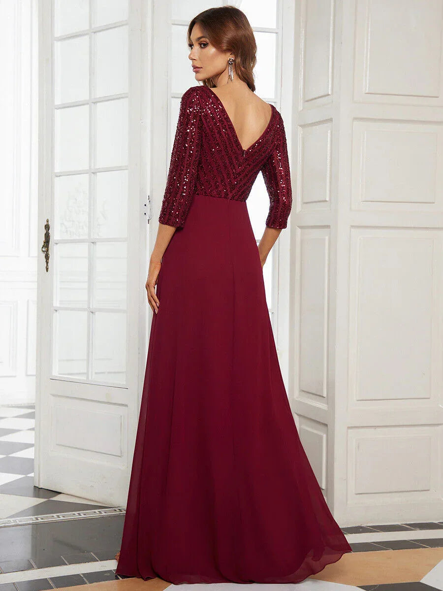 Woman in elegant burgundy evening gown with sequined top and deep V back in bright classic room