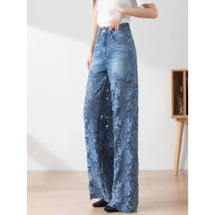 Woman wearing high-waisted wide-leg denim jeans with floral lace detailing at the bottom