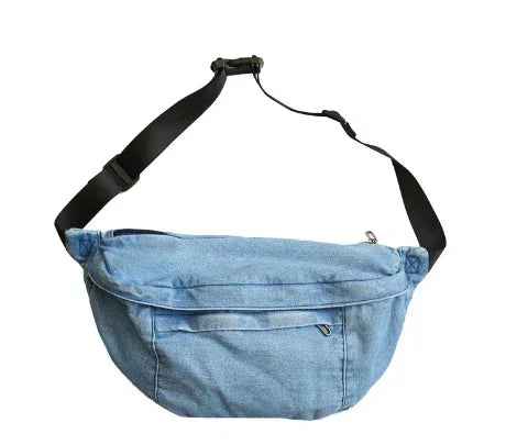 blue denim crossbody bag with black adjustable strap isolated on white background