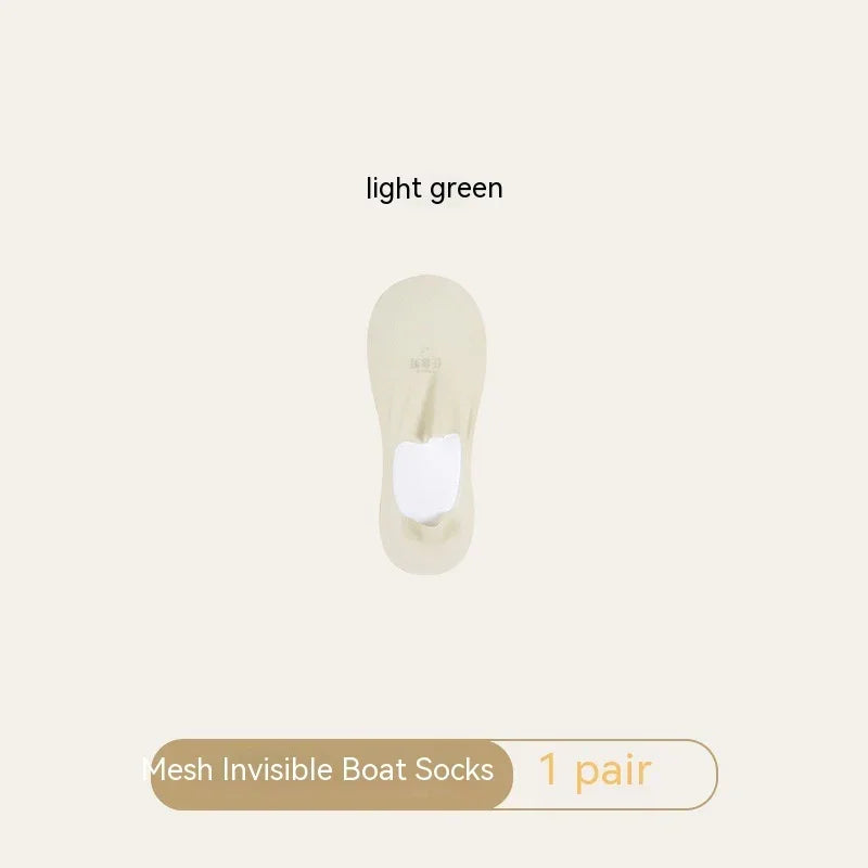 Light green mesh invisible boat socks one pair on beige background