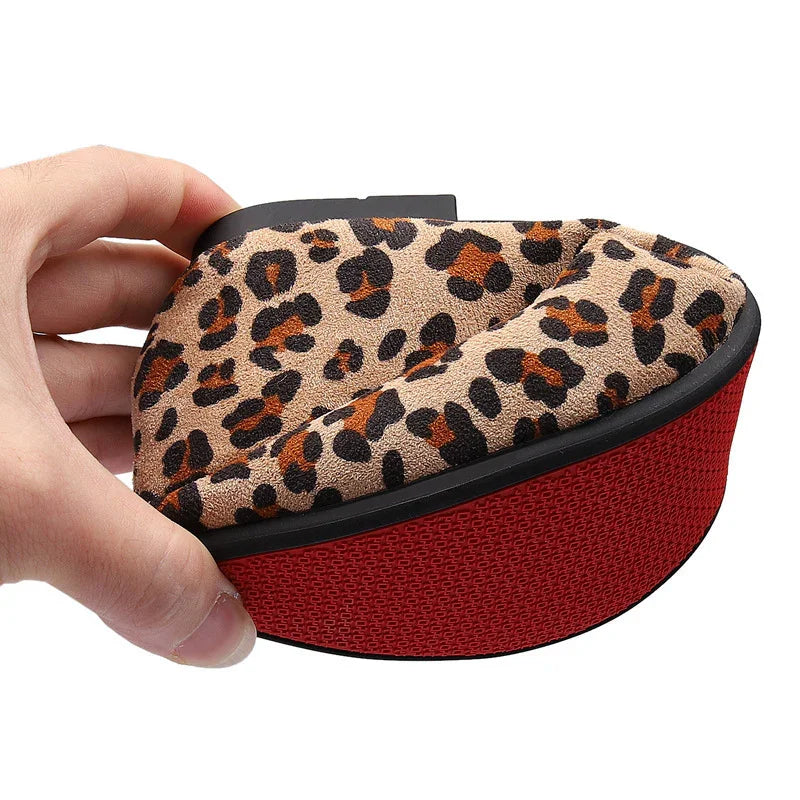 Hand holding a foldable leopard print women's shoe with red sole, showing its flexible design