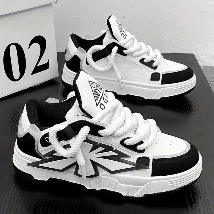 Black and white casual sneakers with thick white laces on black surface next to box labeled 02