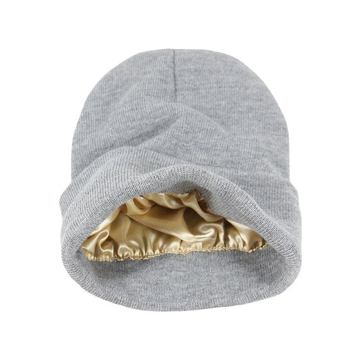 Gray knit satin-lined bonnet hat with shiny gold interior for hair protection